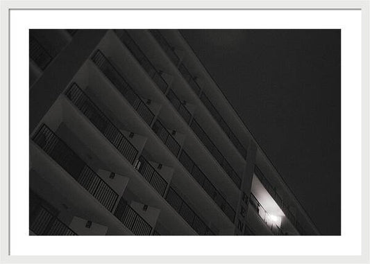 Dimly Lit Beach Hotel Building at Night - Framed Print