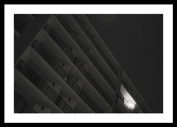 Dimly Lit Beach Hotel Building at Night - Framed Print