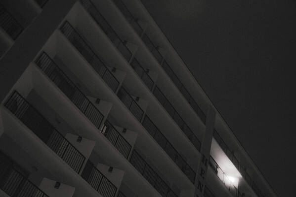 Dimly Lit Beach Hotel Building at Night - Art Print