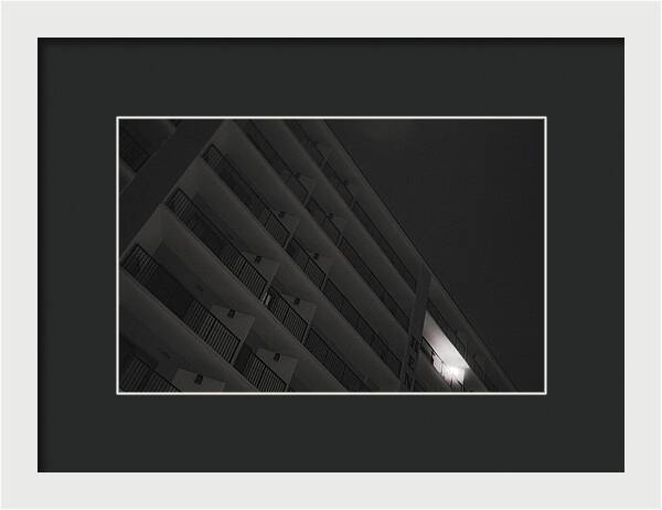 Dimly Lit Beach Hotel Building at Night - Framed Print