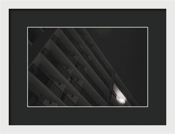 Dimly Lit Beach Hotel Building at Night - Framed Print