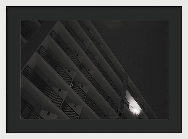Dimly Lit Beach Hotel Building at Night - Framed Print