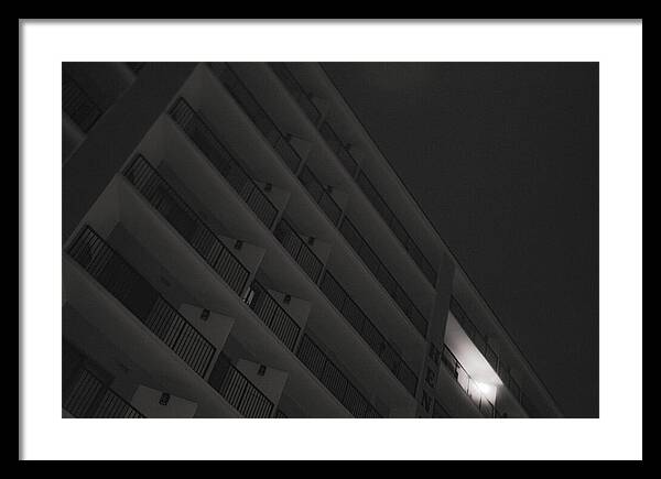 Dimly Lit Beach Hotel Building at Night - Framed Print