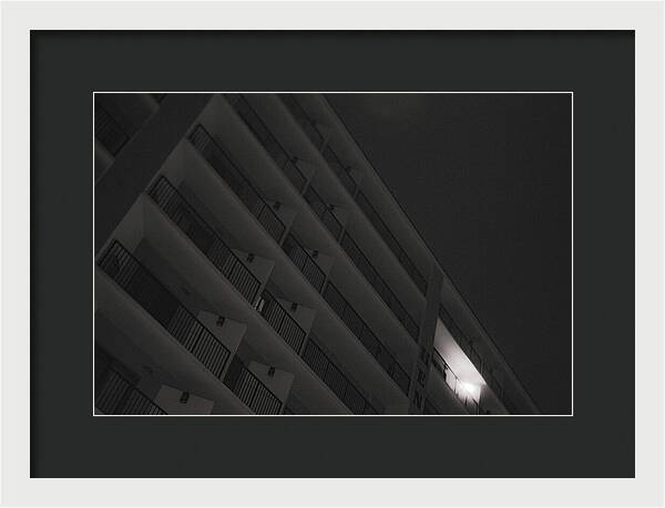 Dimly Lit Beach Hotel Building at Night - Framed Print