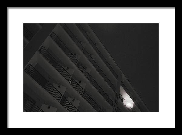 Dimly Lit Beach Hotel Building at Night - Framed Print