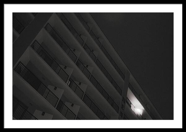 Dimly Lit Beach Hotel Building at Night - Framed Print