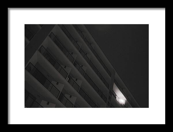 Dimly Lit Beach Hotel Building at Night - Framed Print
