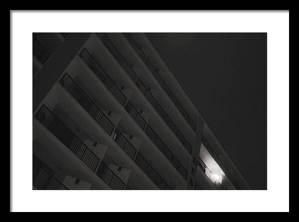 Dimly Lit Beach Hotel Building at Night - Framed Print