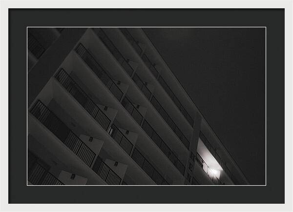 Dimly Lit Beach Hotel Building at Night - Framed Print