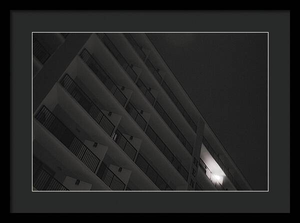 Dimly Lit Beach Hotel Building at Night - Framed Print