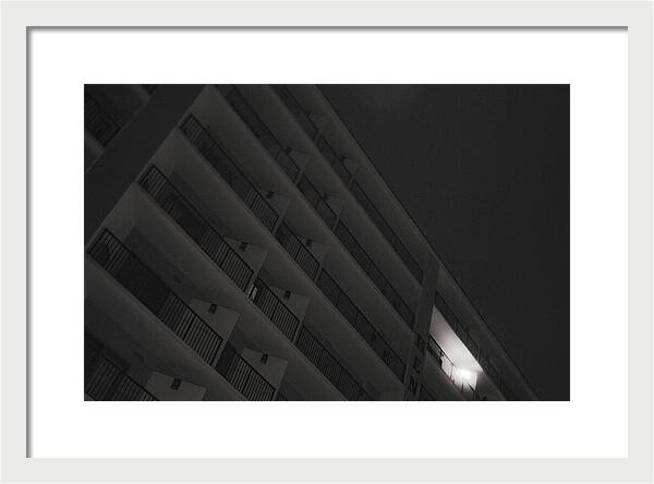 Dimly Lit Beach Hotel Building at Night - Framed Print