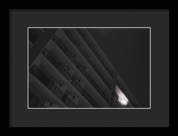 Dimly Lit Beach Hotel Building at Night - Framed Print