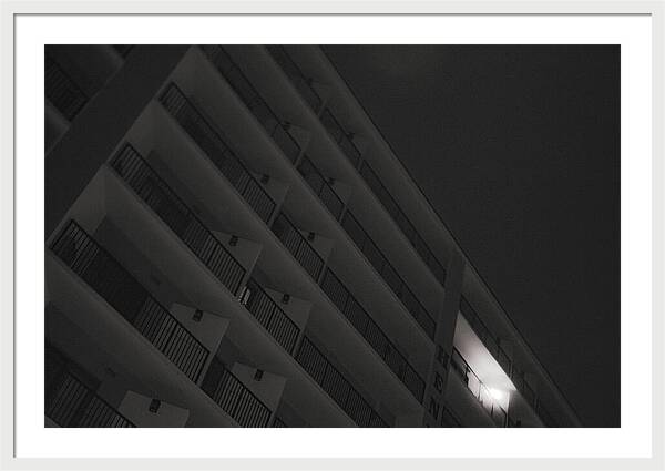 Dimly Lit Beach Hotel Building at Night - Framed Print