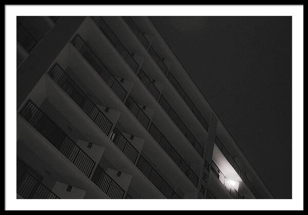 Dimly Lit Beach Hotel Building at Night - Framed Print