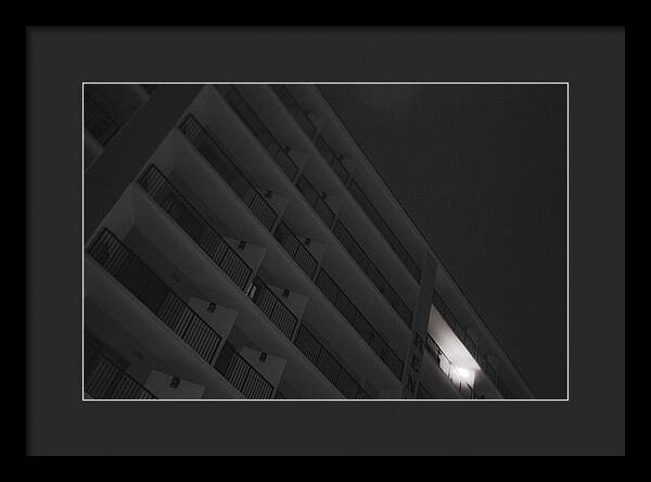 Dimly Lit Beach Hotel Building at Night - Framed Print