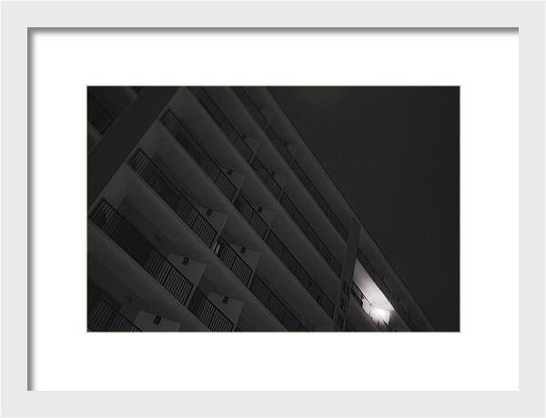 Dimly Lit Beach Hotel Building at Night - Framed Print