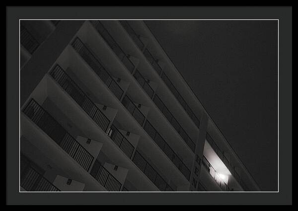 Dimly Lit Beach Hotel Building at Night - Framed Print
