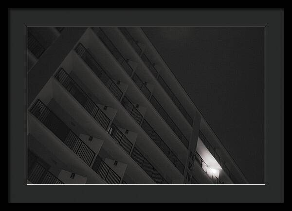 Dimly Lit Beach Hotel Building at Night - Framed Print