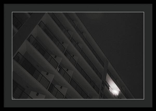 Dimly Lit Beach Hotel Building at Night - Framed Print