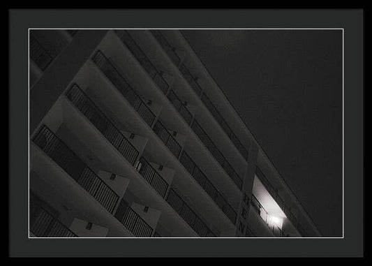 Dimly Lit Beach Hotel Building at Night - Framed Print