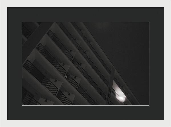 Dimly Lit Beach Hotel Building at Night - Framed Print
