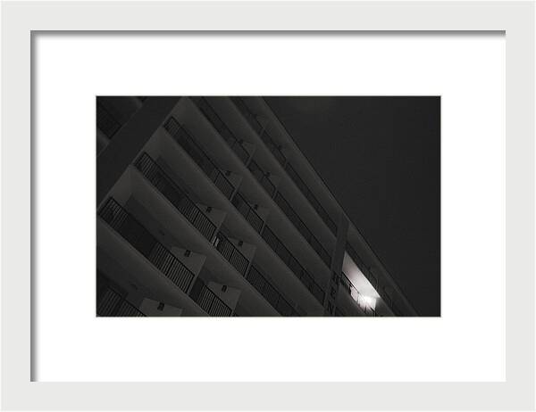Dimly Lit Beach Hotel Building at Night - Framed Print